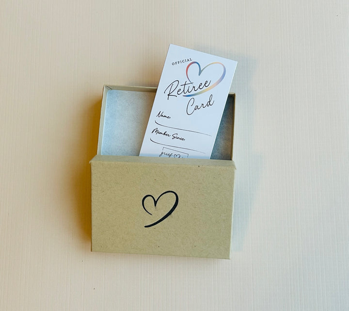 Grief & Joy Official Retiree Card coming out of gift box