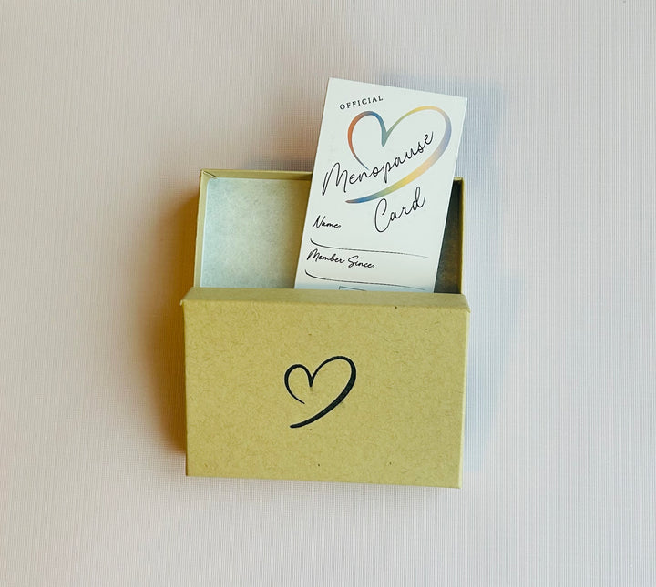 Official menopause card coming out of gift box