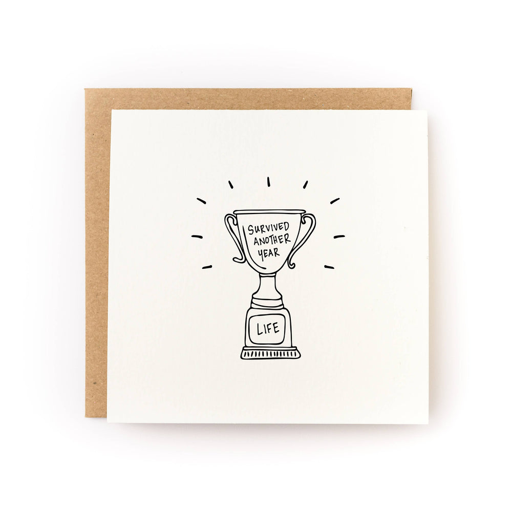 Survived Another Year Trophy Birthday Card front view
Funny birthday greeting card with trophy design
Blank inside birthday card with kraft envelope