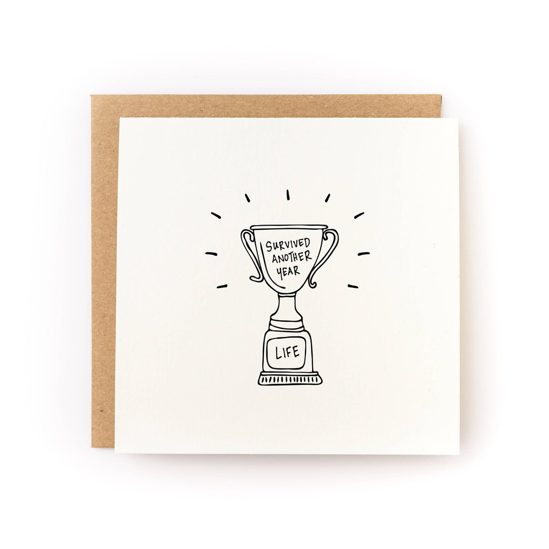 Survived Another Year Trophy Birthday Card front view
Funny birthday greeting card with trophy design
Blank inside birthday card with kraft envelope