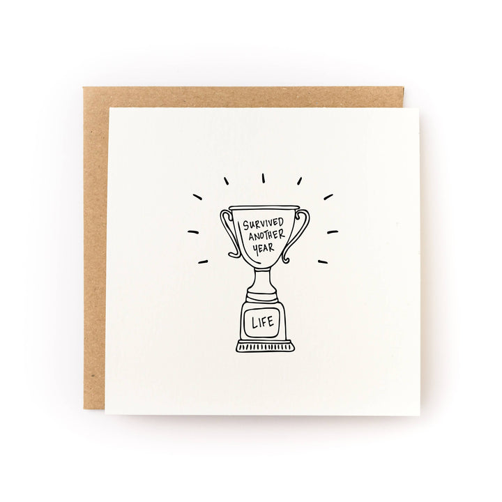 Survived Another Year Trophy Birthday Card front view
Funny birthday greeting card with trophy design
Blank inside birthday card with kraft envelope